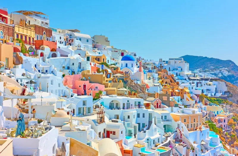 colorful panoramia of oia town in santorini, greece