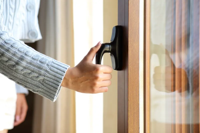 woman hand opening a window door at home