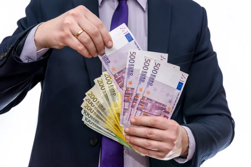 male hands offering euro banknotes in fan