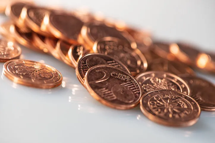 two euro cents a lot of coins lie on a light background, close-up business concept web banner