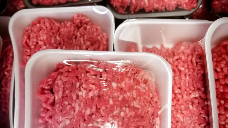 a variety of packages of ground beef at the supermarket