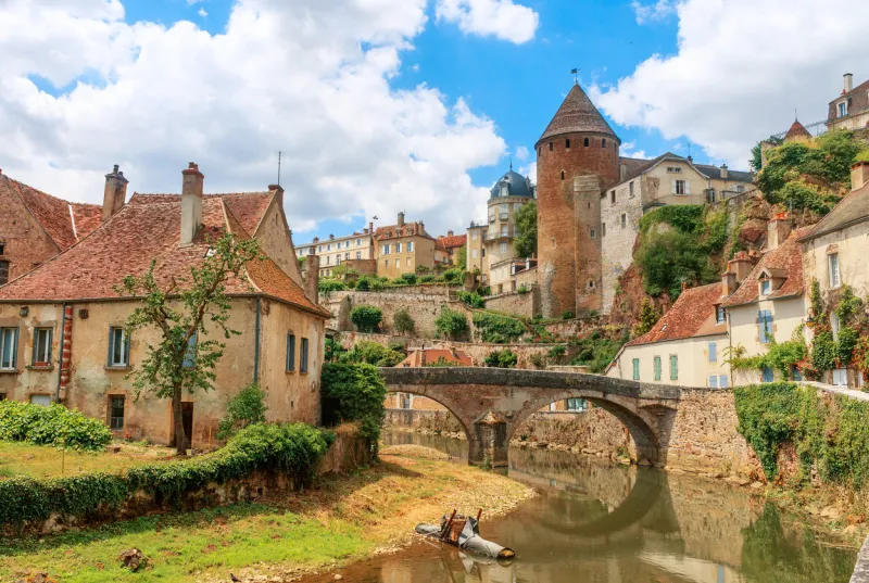 quaint river through the medieval town of semur en auxois, burgundy, france