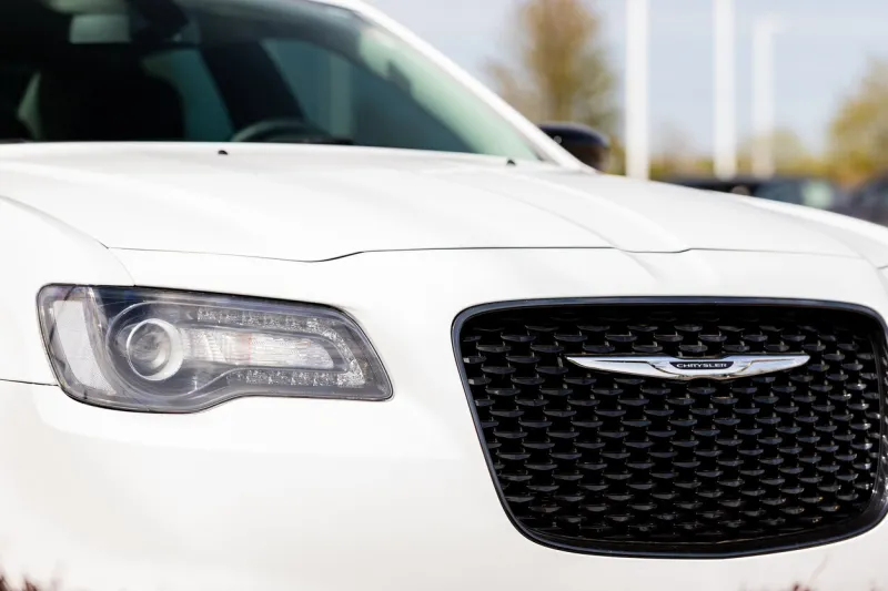 joliet, il, usa - april 28, 2019  the front end of a white 2018 chrysler 300 with a beautiful bokeh   blurred background
