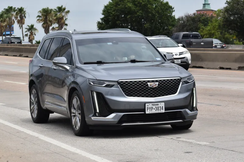 houston, tx usa 5-11-2024 - a gray cadillac xt6 suv cruising down a highway in moderate traffic