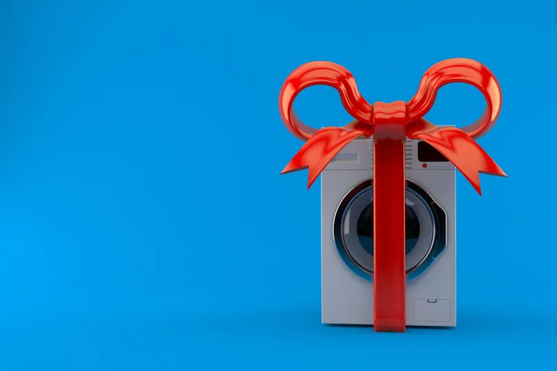 washing machine with red ribbon isolated on blue background 3d illustration