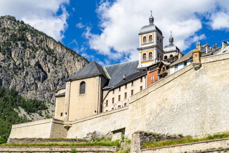 the collegiate church of notre-dame and saint-nicolas overlooking briancon city walls, huates alpes, france