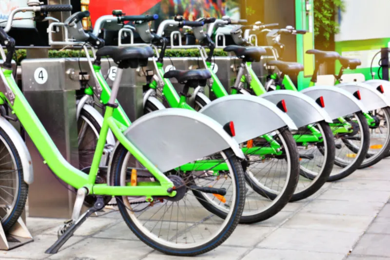 bicycle for rent station on footpath in certra business solve traffic problem