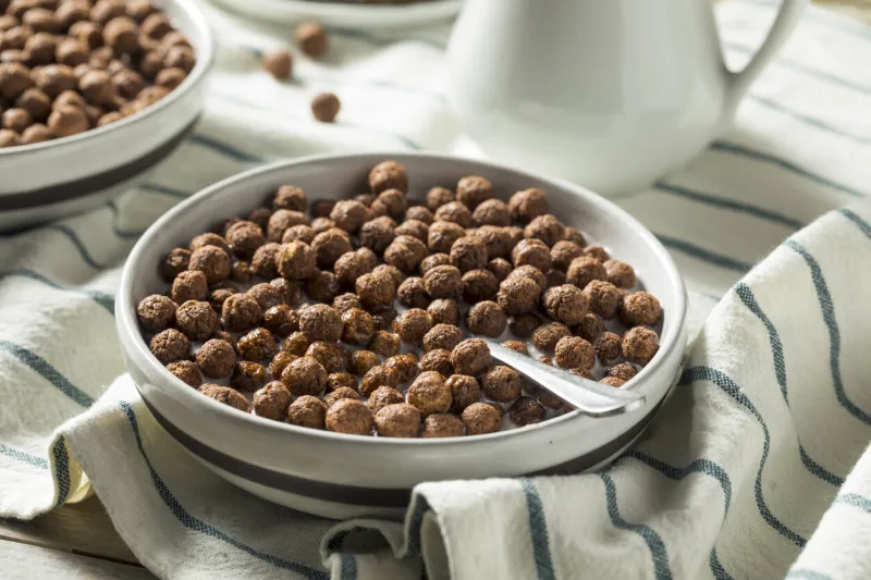 sweet cocoa chocolate sugar cereal puffs with milk