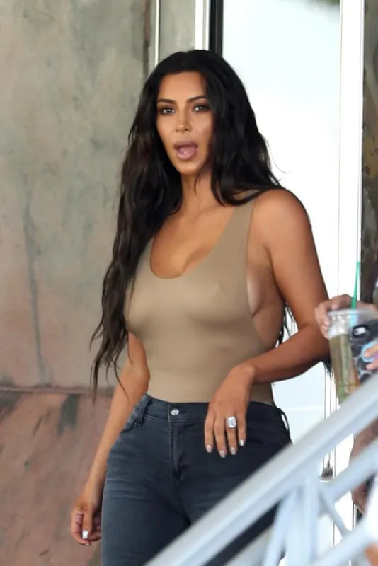 kim kardashian shows off the results of her deep spray tan as she heads to dash with sister kourtney in miami