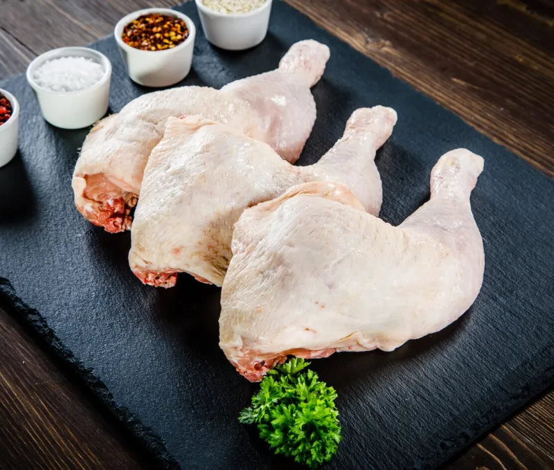 raw chicken legs on cutting board