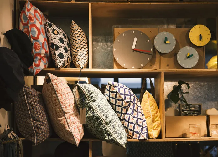 pillows and handmade clocks in an elegant shop