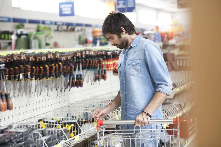 male customer buying tools at hardware store