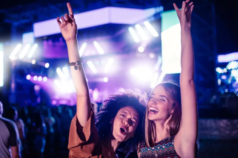 two young women having fun at a music festival
