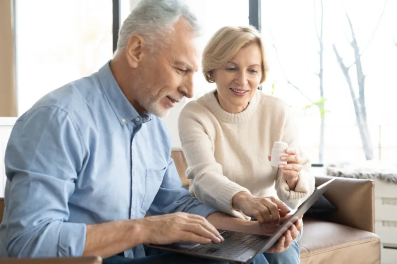 retired couple looking for prescription pills on internet online shopping process of remote consulting with doctor buying medicines online on laptop