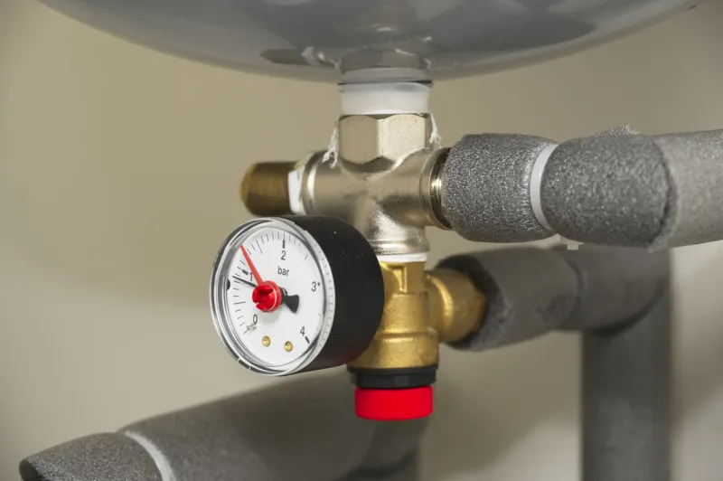 pressure gauge on domestic boiler expansion vessel inside house uk