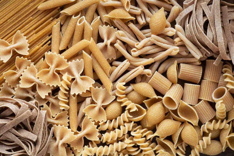 variety of types and shapes of wholemeal pasta dry integral pasta background