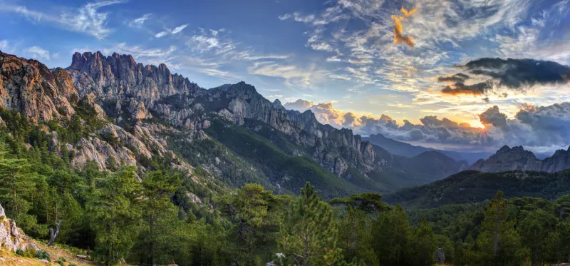 sunrise and cloudscape over bavella massif and mountain, corsica, france