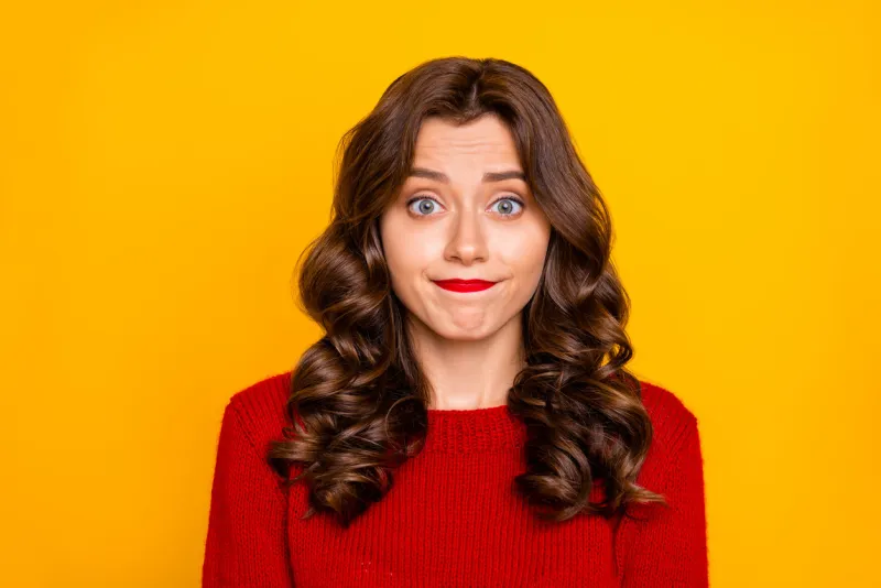 photo of curly wavy white uncertain girlfriend unsure about quality of her life standing, isolated with yellow vivid color background