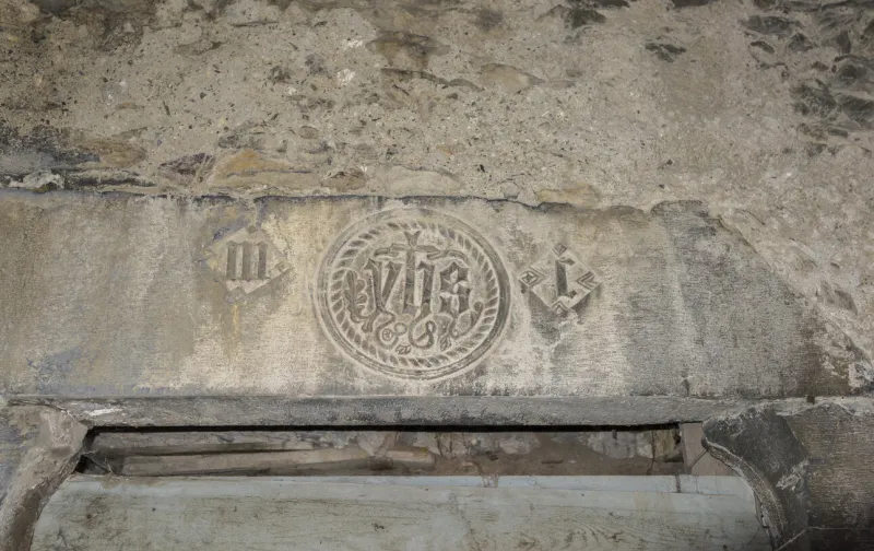 triora, italy - october 31, 2015  medieval stone lintel engraved with the initials of the house owner
