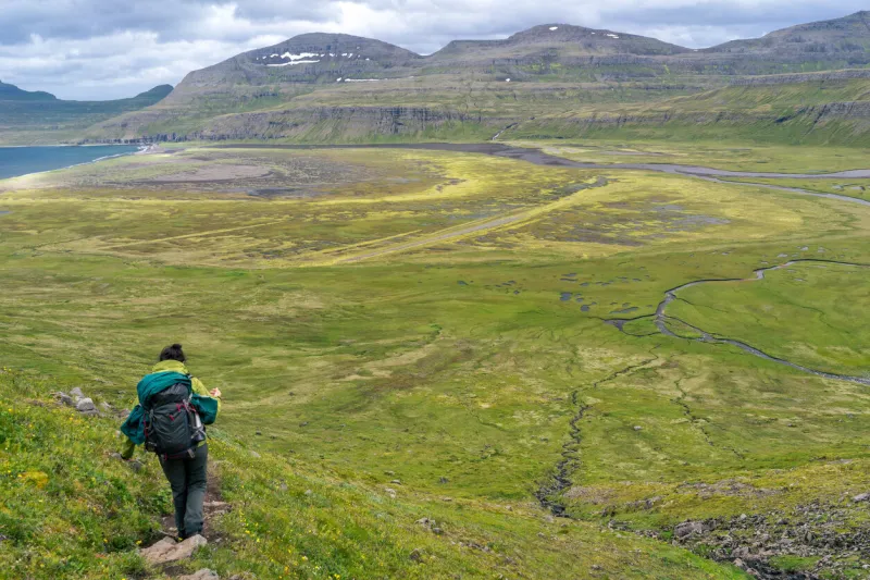 woman hiking in most the isolated icelandic national park - hornstrandir