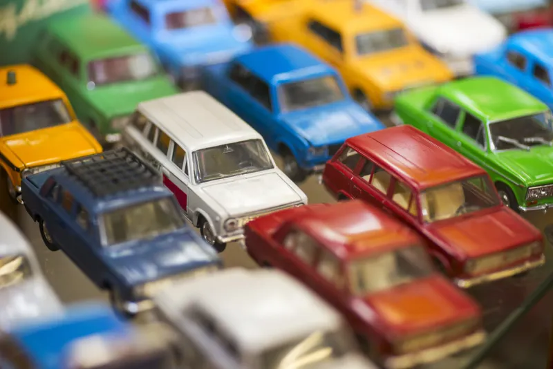 big collection of retro car models on the shelf miniatures of colorful vintage vehicles in the shop selective focus
