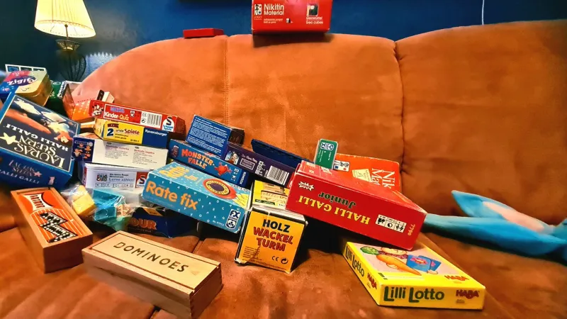 games collection, terracotta sofa in front of blue wall
