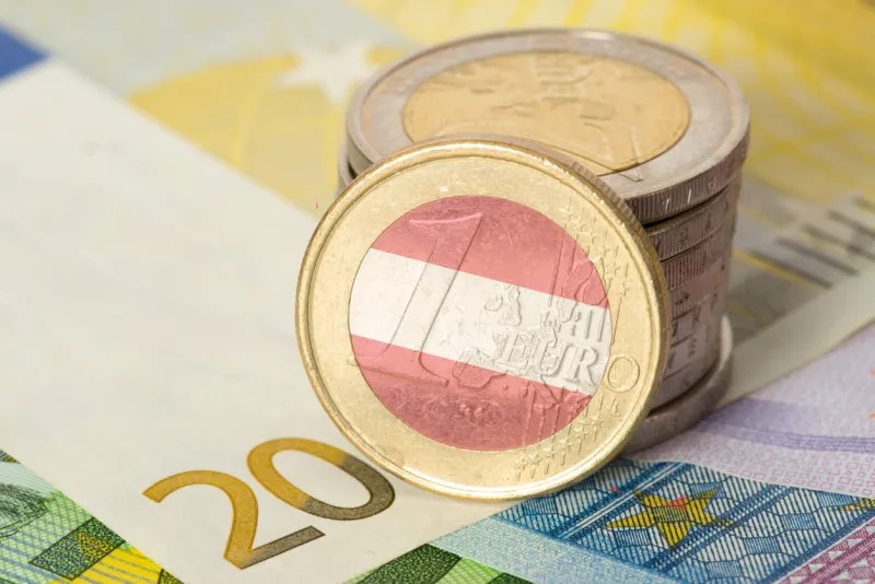 euro banknotes and coins and flag of austria