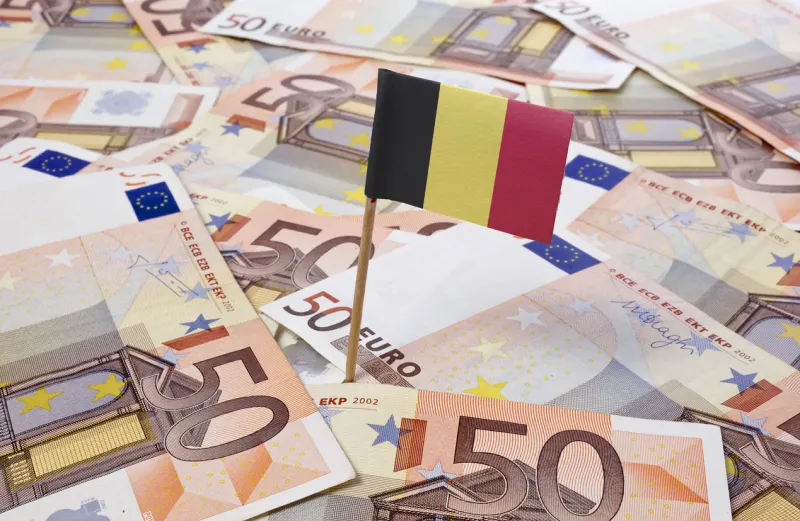 flag of belgium sticking in european bank notes