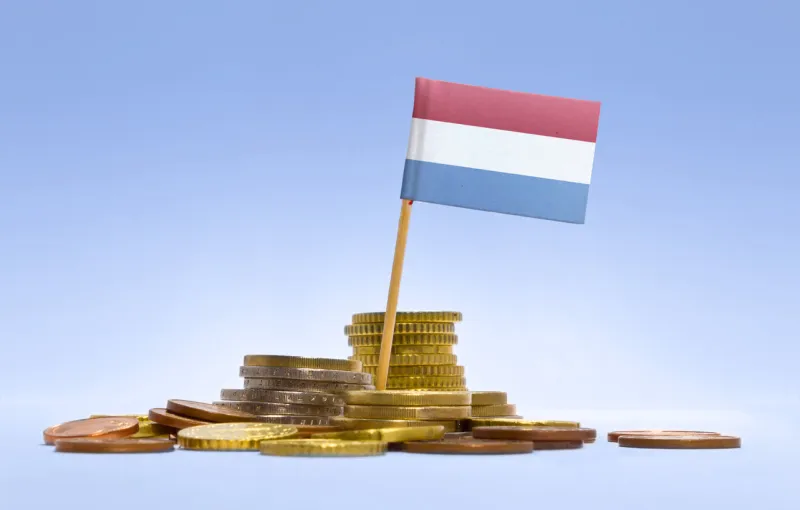flag of luxembourg in a mixed stack of european coins and a blue background(series)