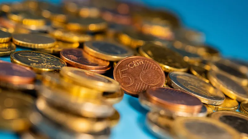 euro cents and coins of one and two euro denominations lie on a blue background photo for design