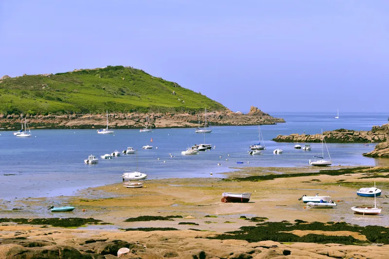 port and beach at low tide on the pink granite coast (côte de granite rose in french) at trébeurden, commune in the côtes-d'armor department of brittany in northwestern france