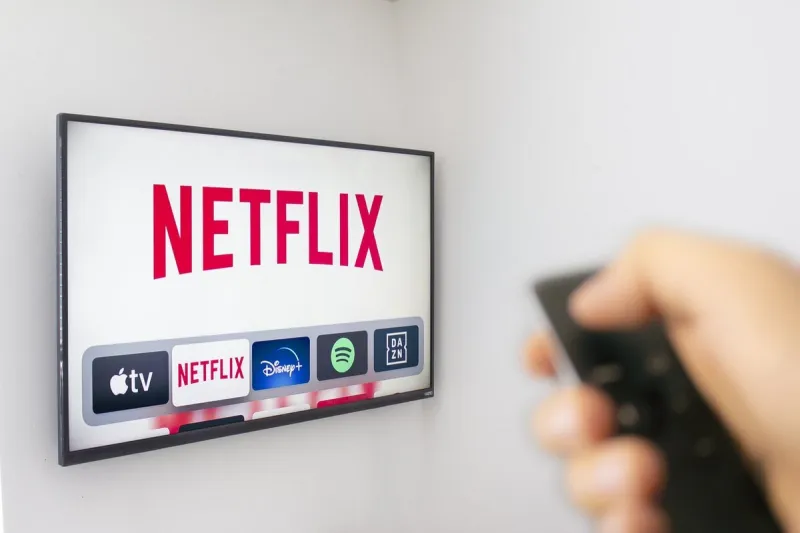 calgary, alberta canada dec 9 2019  a person holds an apple tv remote using the new netflix app with a hand netflix dominates golden globe nominations illustrative