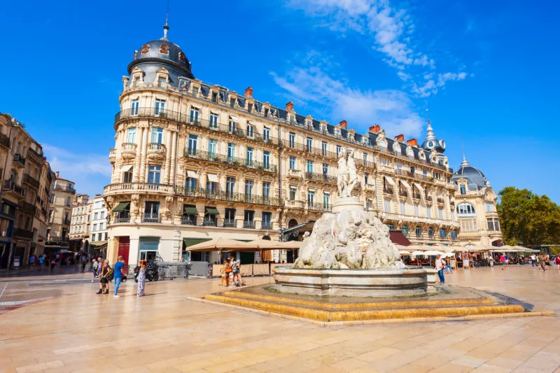 fountain of the three graces at the place de la comedie, main square in montpellier city in southern france people are with blurred faces