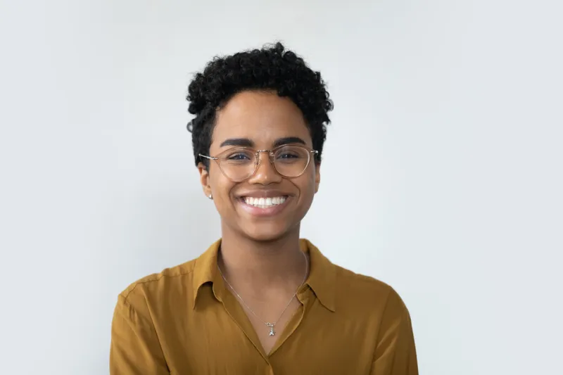happy millennial afro american business woman in casual glasses posing isolated on white, smiling with perfect white teeth confident female customer, professional head shot portrait