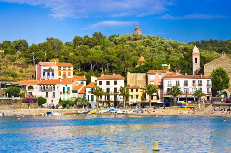 collioure, france - july 05, 2016  tourists on beach and hotels in collioure, roussillon, vermilion coast, pyrenees orientales, france