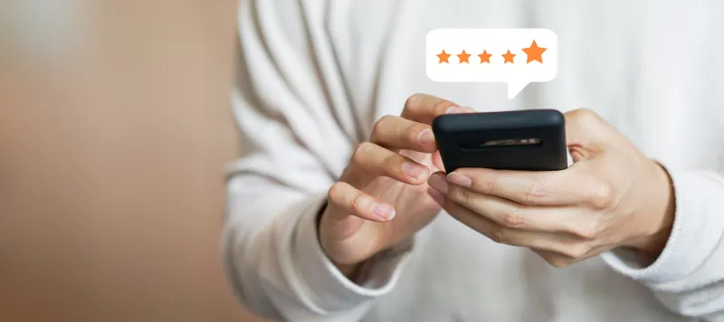 close up on customer man hand pressing on smartphone screen with gold five star rating feedback icon and press level excellent rank for giving best score point to review the service , technology business concept
