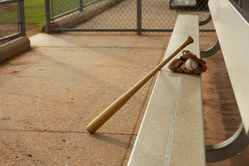baseball & bat and glove in the dugout