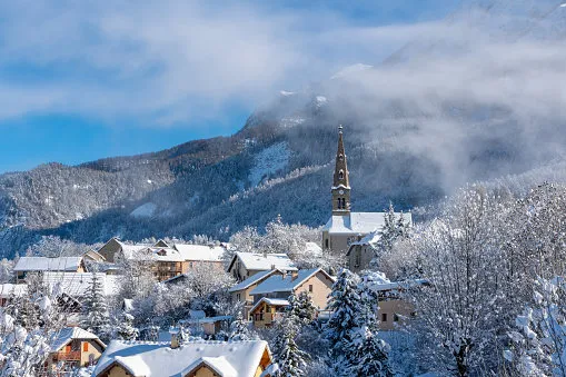 the village of saint leger les melezes in the champsaur valley covered in snow in winter ski resort in the ecrins national park, french alps, hautes alpes, france