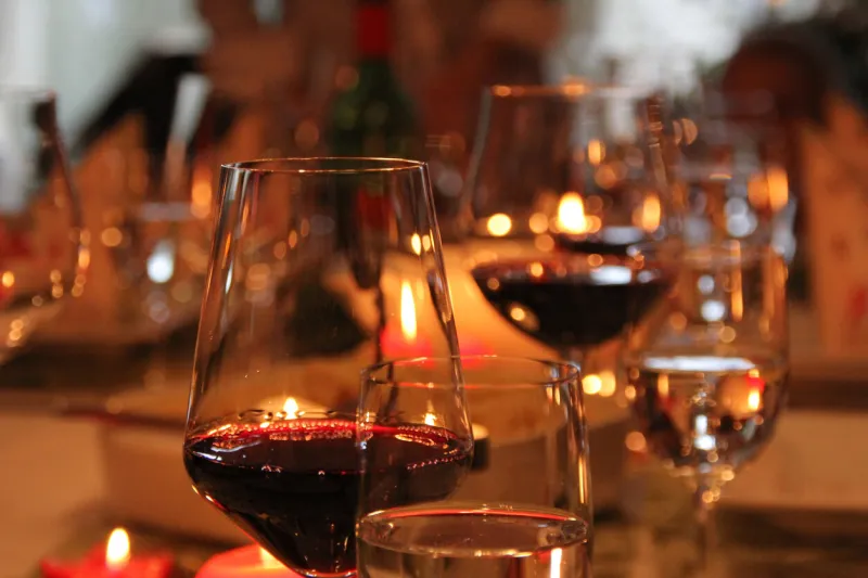festive christmas decoration with red wine in wine glasses on a table in fulda, germany