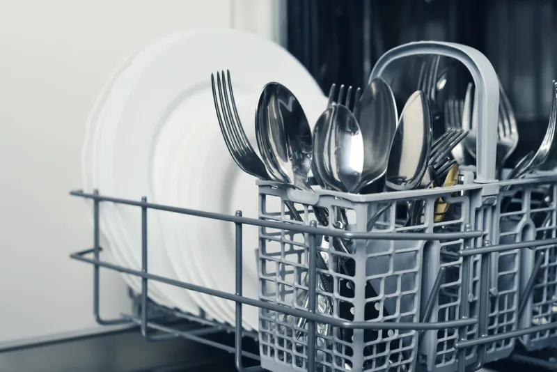 clean cutlery and plates after washing in dishwasher machine