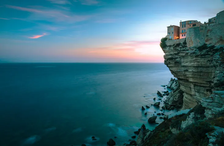 sunset over the old town of bonifacio, the limestone cliff, south coast of corsica island, france
