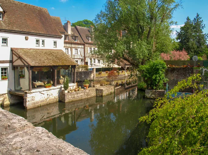 river l´eure with trees and houses in the old town of chartres in france