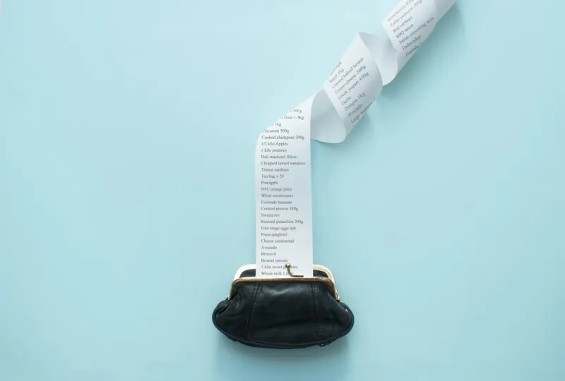 large receipt coming out of purse, inflation, food rising costs concept