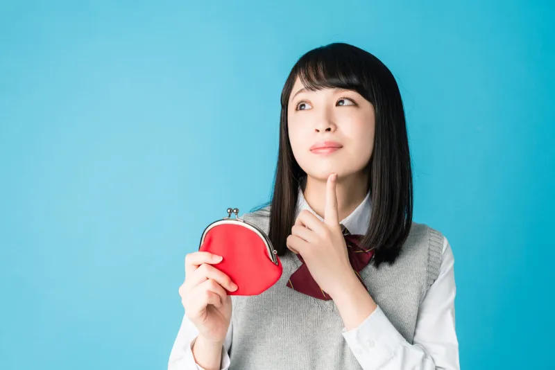 asian school girl holding a coin purse