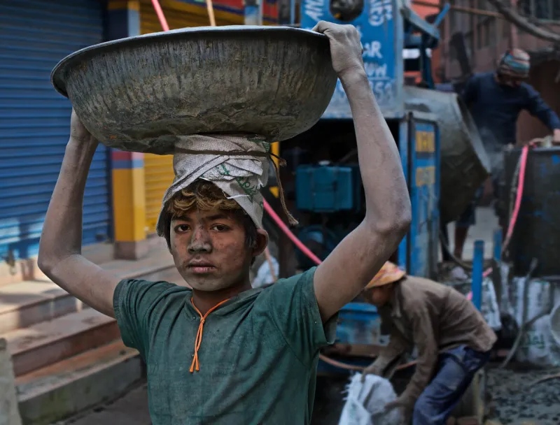 kathmandu, nepal - january 17th, 2015  homeless boys are working in construction for a food and shelter in the capital city of nepal