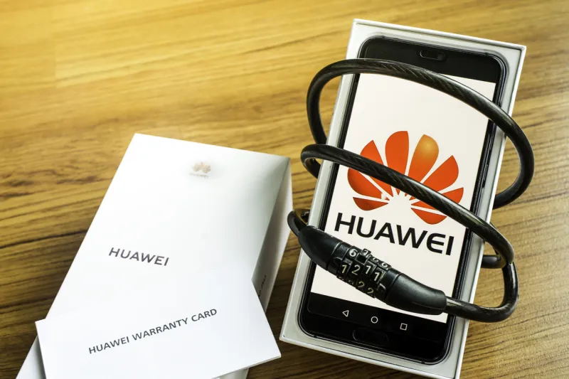 bangkok, thailand - may 23, 2019  huawei phones with decoders on artificial wood flooring in the home, huawei security issues, business crises, huawei logo screens
