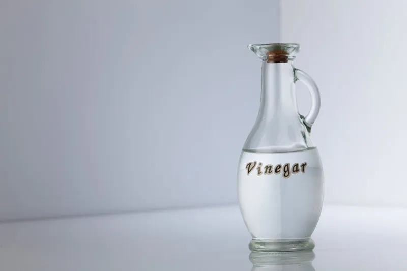 bottle of white vinegar on gray white background