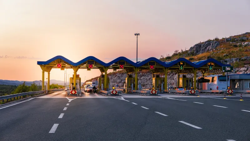 cars passing through the toll gate on the motorway, vivid travel background