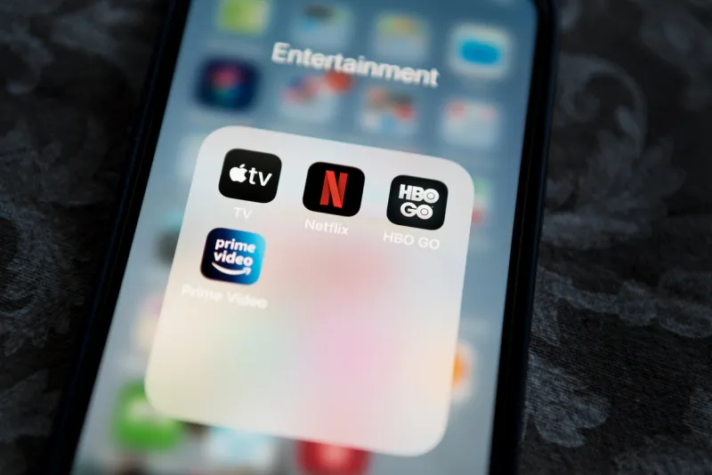 krakow, poland - november 28, 2021  netflix application icon among apple tv+, amazon prime video, and hbo go in entertainment folder on apple iphone 12 pro max screen close-up popular streaming services