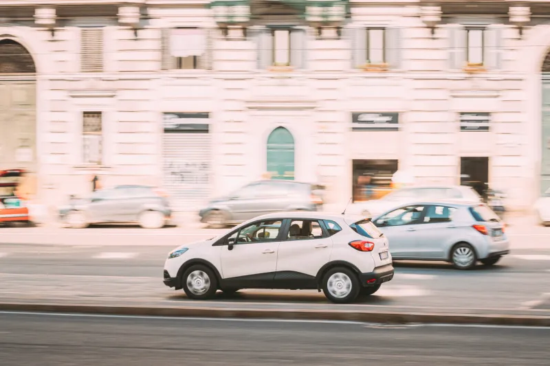 rome, italy - october 21, 2018  white color renault captur car fast moving at street